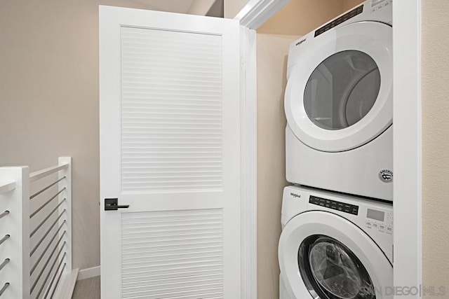 laundry room with stacked washer and dryer