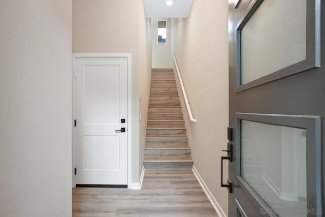 staircase with hardwood / wood-style floors