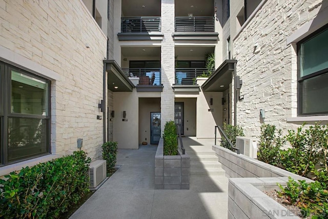 property entrance featuring central AC unit