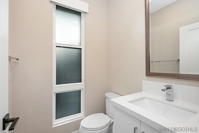 bathroom with toilet and vanity