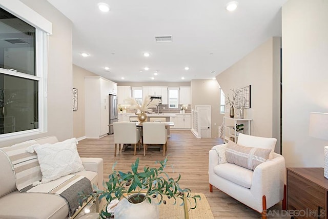 living room with light hardwood / wood-style flooring