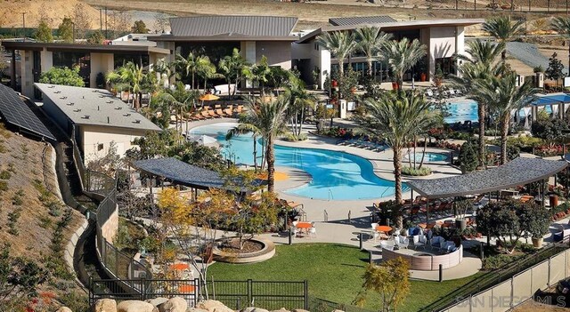 view of swimming pool with a lawn