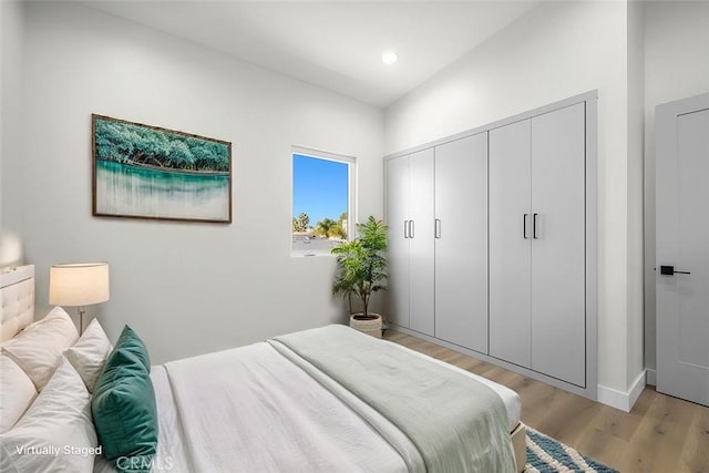 bedroom featuring light hardwood / wood-style floors and a closet