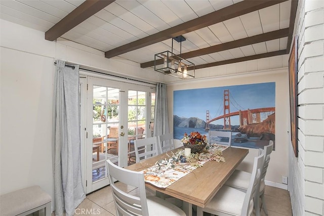 tiled dining room featuring beamed ceiling, french doors, and wooden ceiling