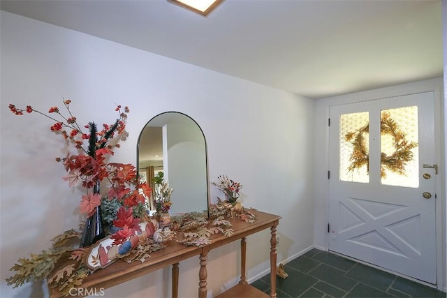 entryway with dark tile patterned flooring