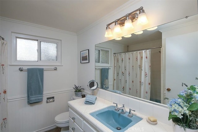 bathroom featuring vanity, toilet, curtained shower, and crown molding