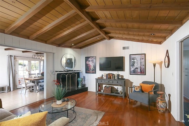 living room featuring lofted ceiling with beams, french doors, wooden ceiling, and hardwood / wood-style flooring