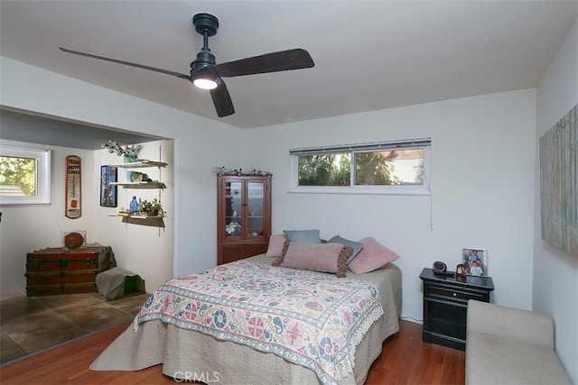 bedroom featuring ceiling fan and dark wood-type flooring