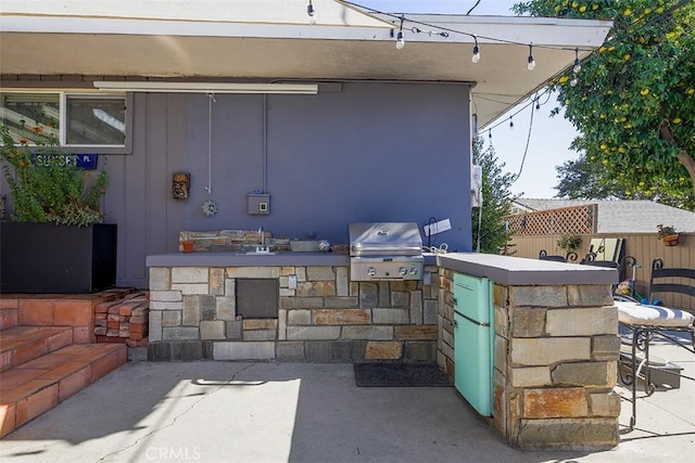 view of patio / terrace featuring a bar, area for grilling, and grilling area