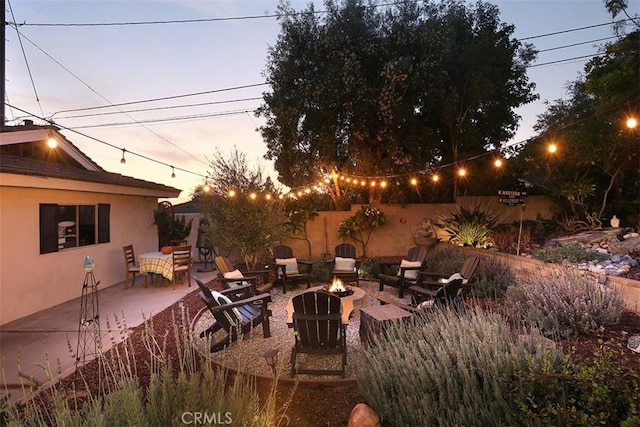 patio terrace at dusk with a fire pit