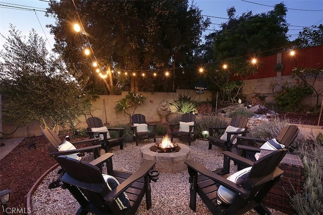 patio terrace at dusk with an outdoor fire pit