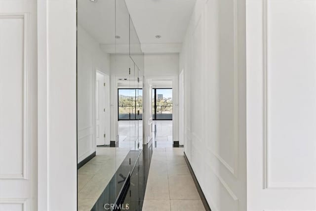 corridor featuring light tile patterned flooring