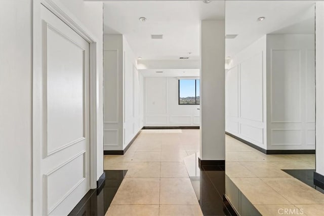 hallway featuring light tile patterned floors