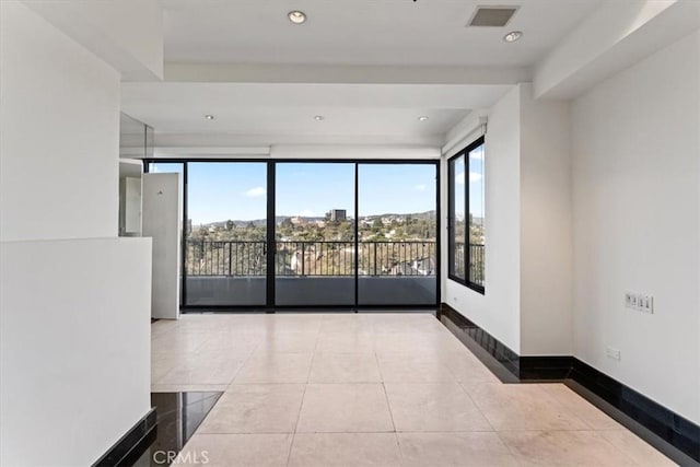 unfurnished room featuring light tile patterned floors