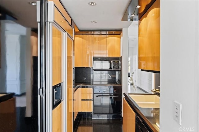 kitchen with tile patterned floors, decorative backsplash, sink, and black appliances