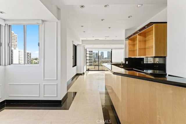 kitchen with light tile patterned floors and a healthy amount of sunlight