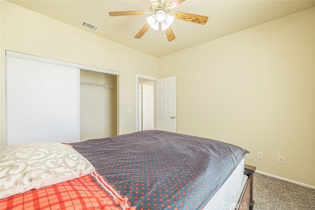 carpeted bedroom featuring ceiling fan and a closet