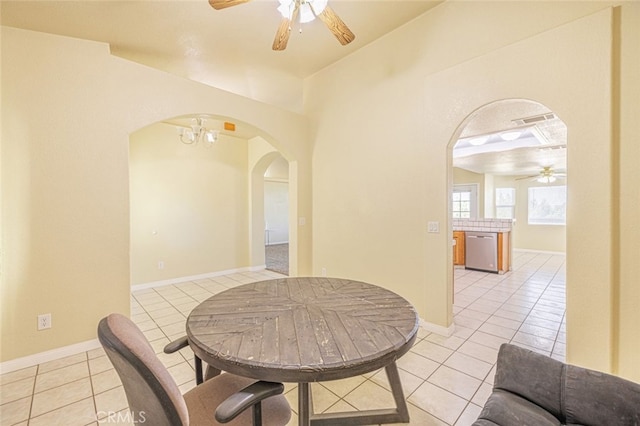 tiled dining area with a chandelier