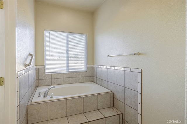 bathroom featuring tiled tub