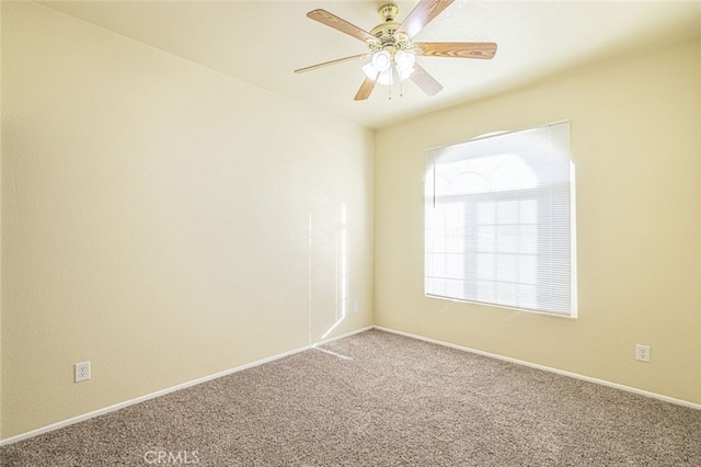 carpeted empty room featuring ceiling fan