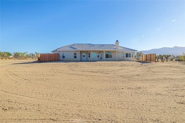 back of house featuring a mountain view