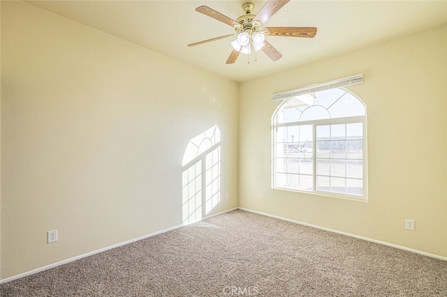 empty room featuring carpet floors and ceiling fan