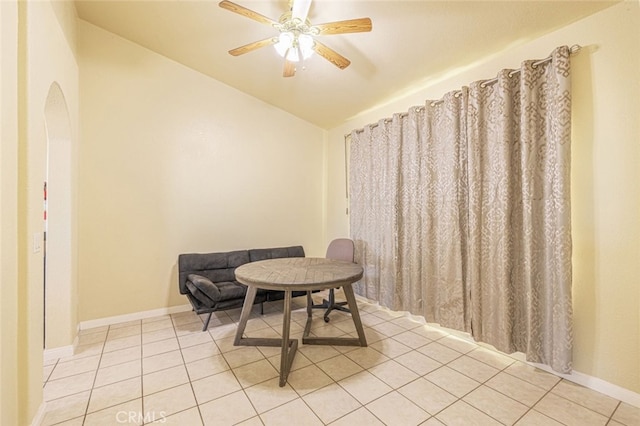 living area with ceiling fan, light tile patterned flooring, and lofted ceiling