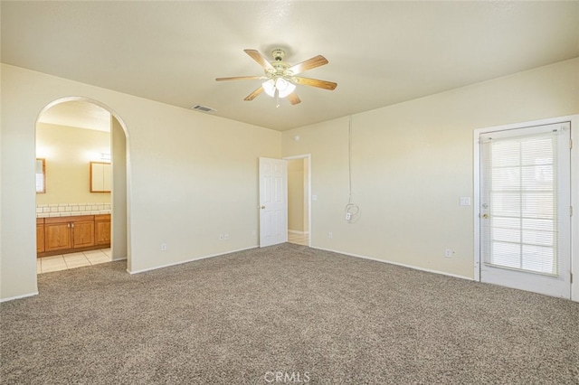 carpeted spare room featuring ceiling fan