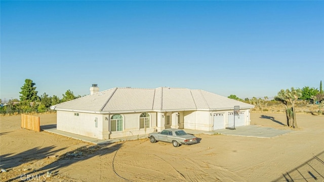 rear view of property featuring a garage