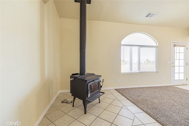 room details featuring carpet and a wood stove