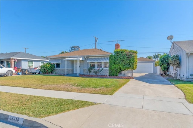 single story home featuring an outbuilding, a front yard, and a garage