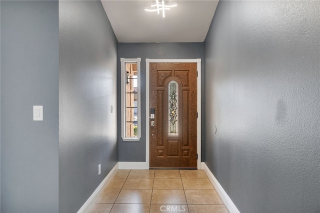 doorway with light tile patterned floors