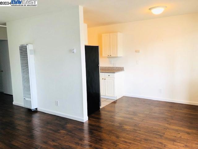 kitchen featuring dark hardwood / wood-style floors and white cabinetry