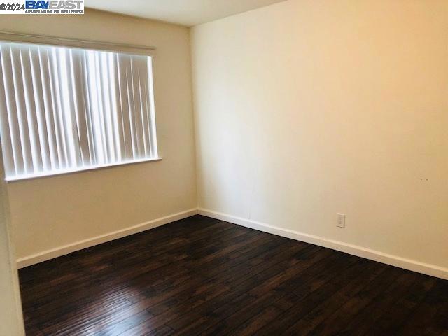 empty room featuring dark hardwood / wood-style flooring