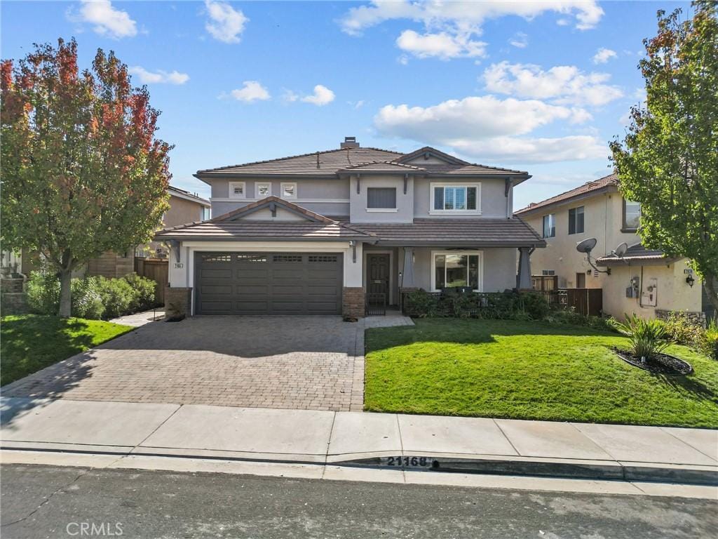 view of front of property with a garage and a front yard