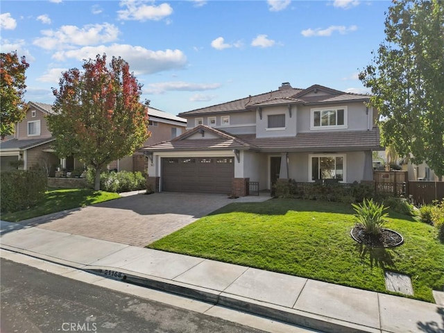 view of front of home featuring a front yard and a garage