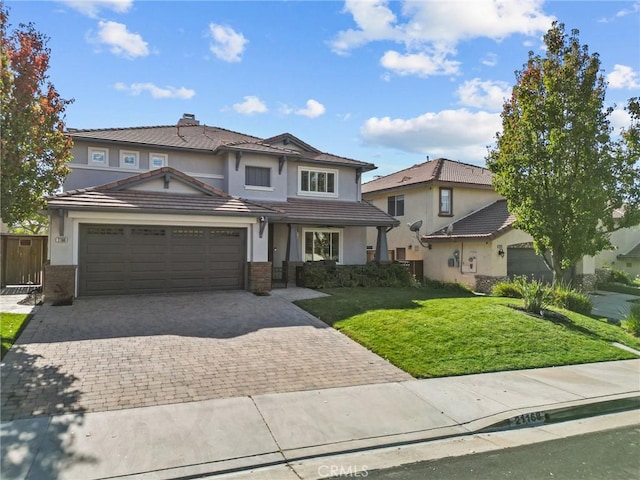 front of property with a front yard and a garage