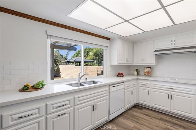 kitchen with sink, white cabinetry, tasteful backsplash, hardwood / wood-style floors, and white appliances