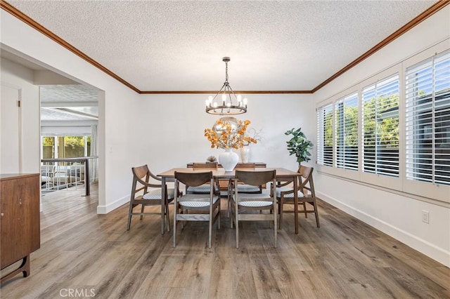 dining room featuring hardwood / wood-style flooring, an inviting chandelier, and plenty of natural light