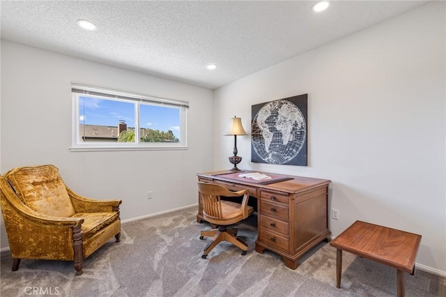 carpeted office with a textured ceiling