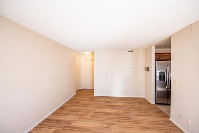 spare room featuring light hardwood / wood-style floors