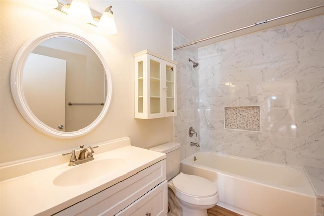 full bathroom with toilet, vanity, and tiled shower / bath combo