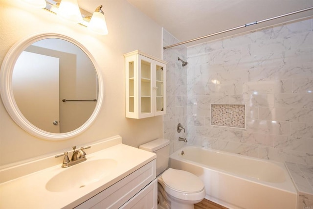 full bathroom with toilet, vanity, and tiled shower / bath combo