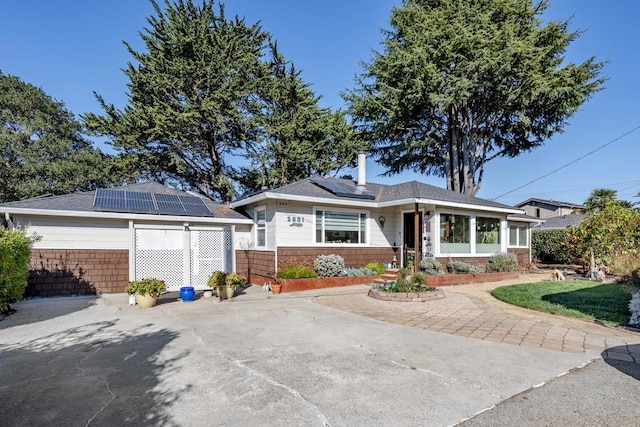 single story home featuring solar panels