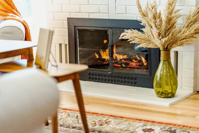 interior details featuring a brick fireplace