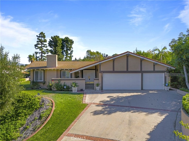 ranch-style house featuring a front lawn and a garage