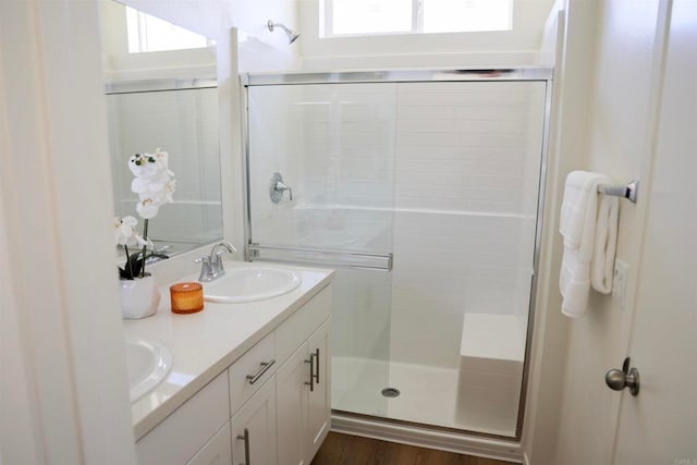 bathroom featuring hardwood / wood-style floors, vanity, and an enclosed shower