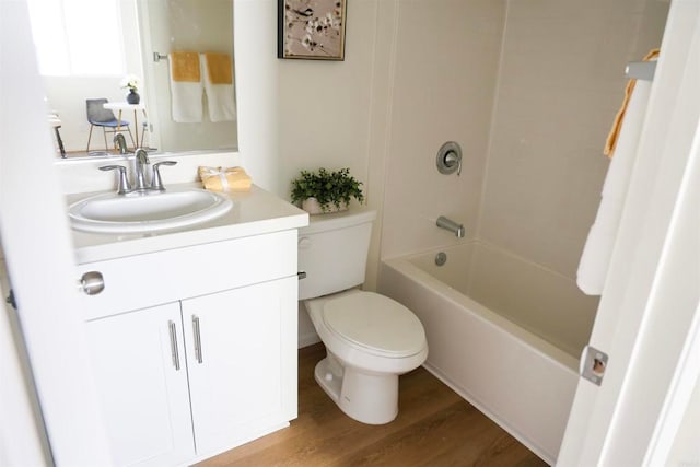 full bathroom with vanity, wood-type flooring, bathtub / shower combination, and toilet