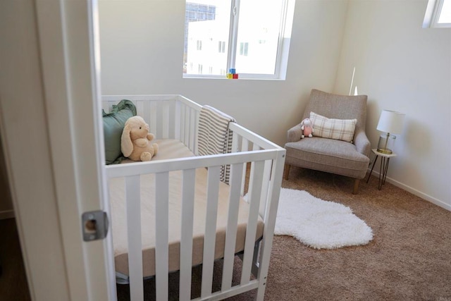 carpeted bedroom with a nursery area