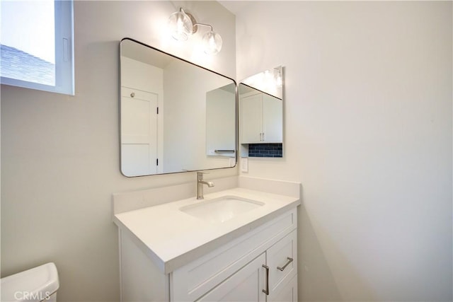 bathroom featuring vanity and toilet